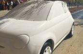 white FIAT 500 3-door hatchback copy parked on brown pavement at daytime