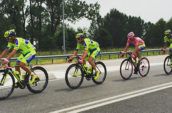 four men riding bicycles at road during daytime