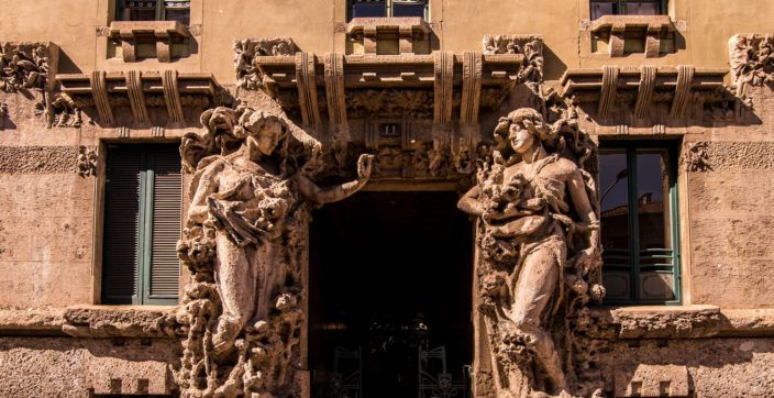two statues standing near doorway