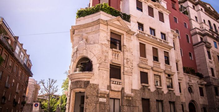 photography of red and white building on the corner of the street