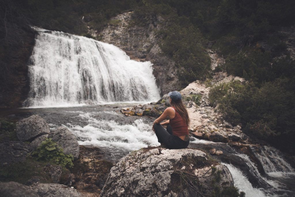 woman sitting on rock formation