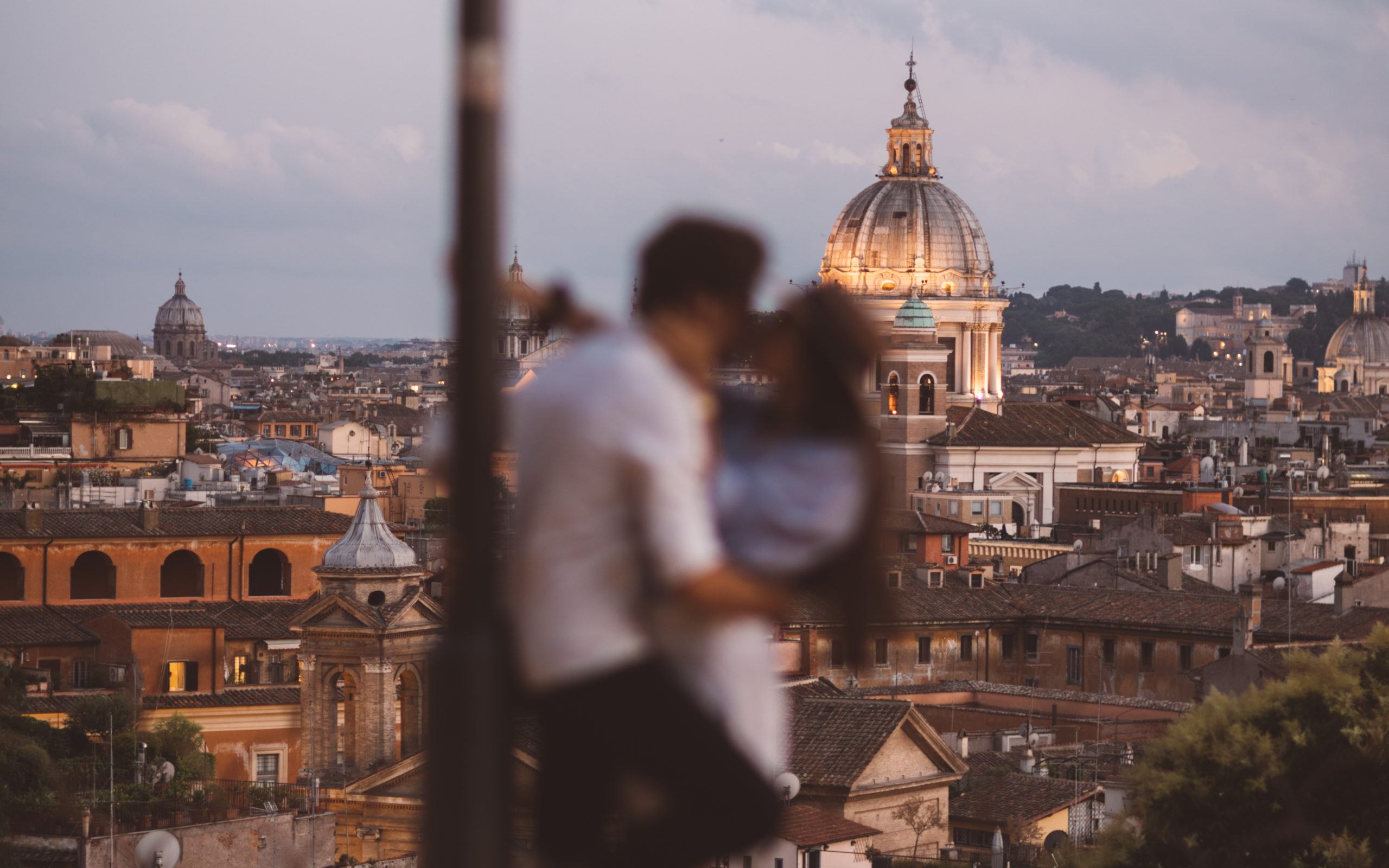 Couple in love kissing in Rome during the golden hour