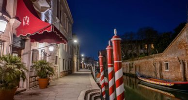 Exterior of the Grand Hotel Dei Dogi by the side of a canal in Venice